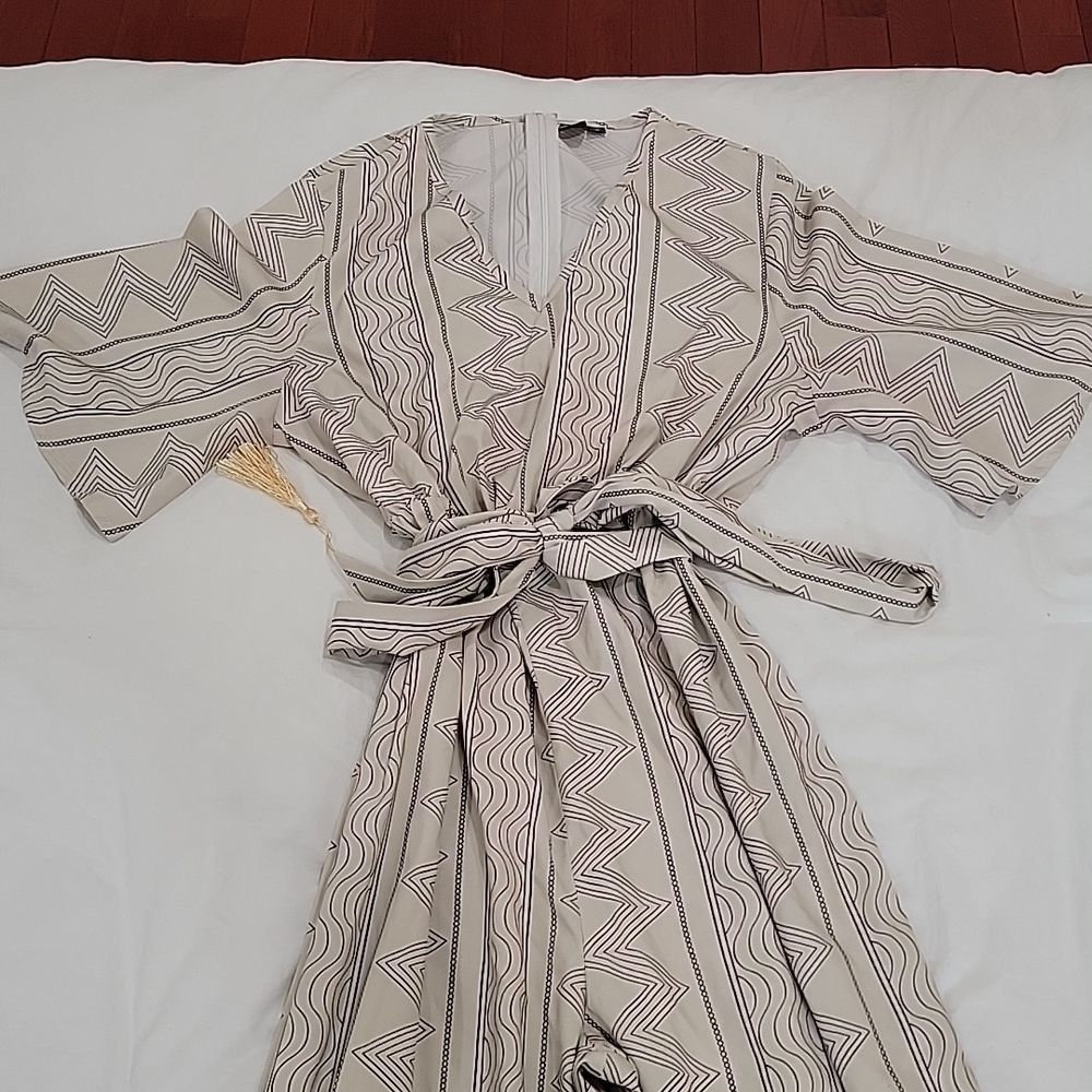 Printed jumpsuit with tie at waist / tassel detail at hem of pants